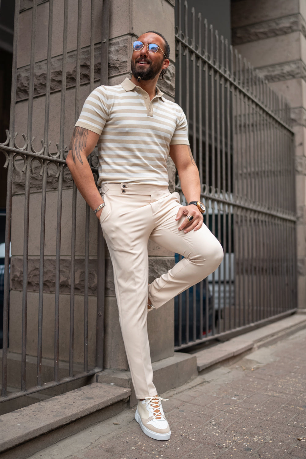 Light beige pleated trousers for men by Mazonni styled with striped polo and sneakers