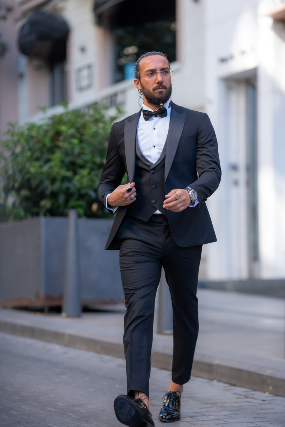 Elegant black suit from Mazonni paired with a bow tie and dress shoes, luxury formal outfit