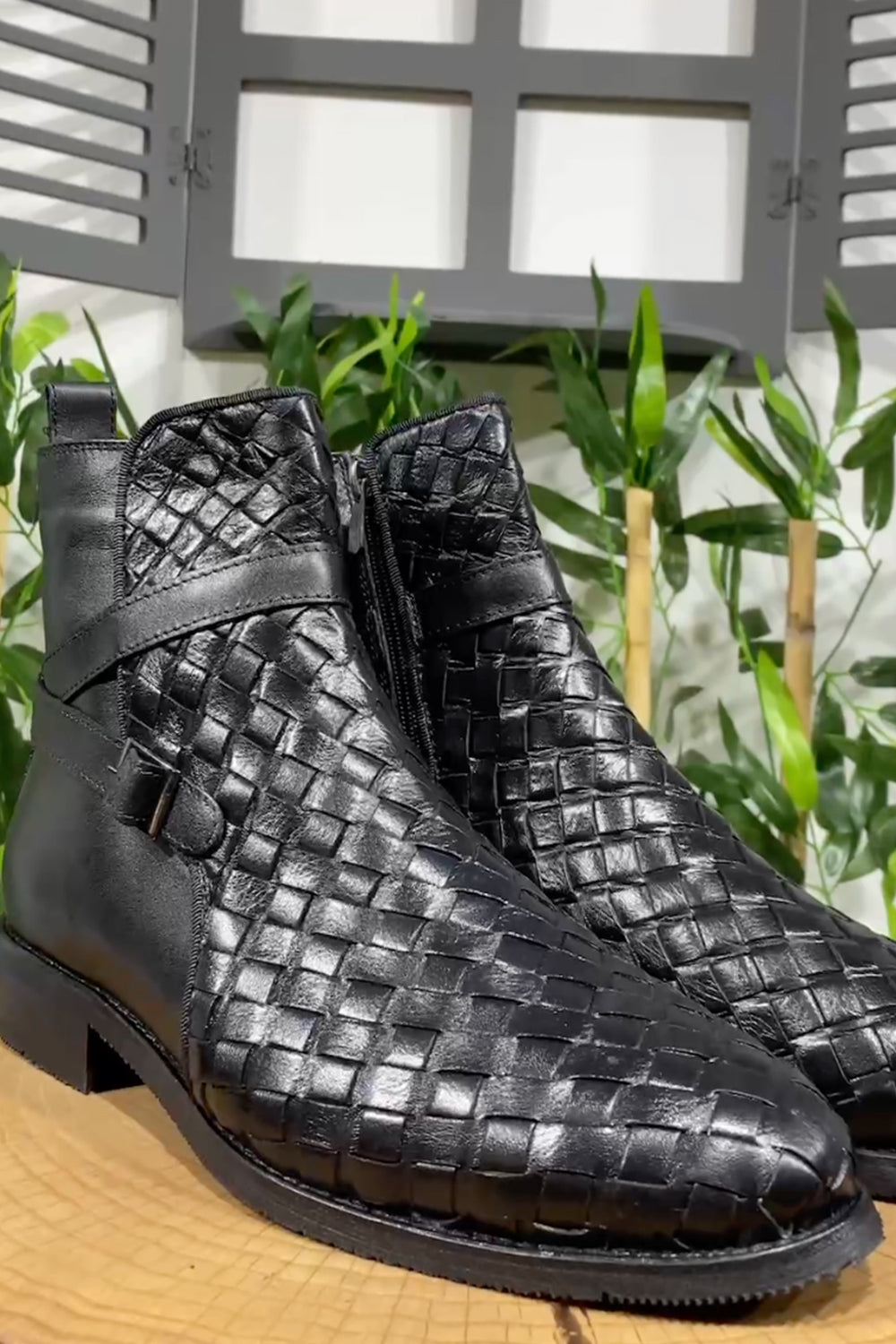 Pair of black Mazonni woven leather boots with classic toe design and sleek finish