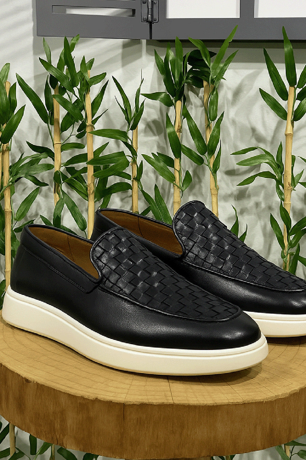 Black woven leather slip-on shoes for men by Mazonni with white rubber sole for casual style