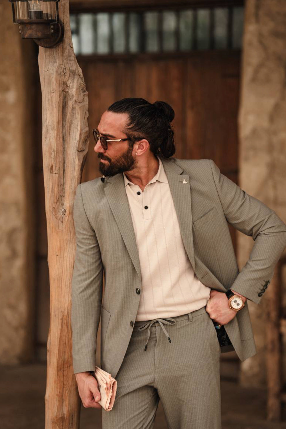 Stylish men's sage green suit by Mazonni paired with casual white top, great for smart casual and semi-formal events