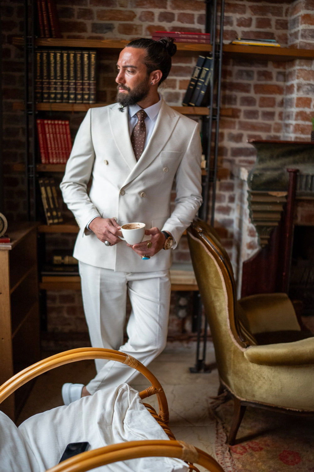 Off-white tailored suit by Mazonni paired with subtle accessories, classic menswear look with refined details