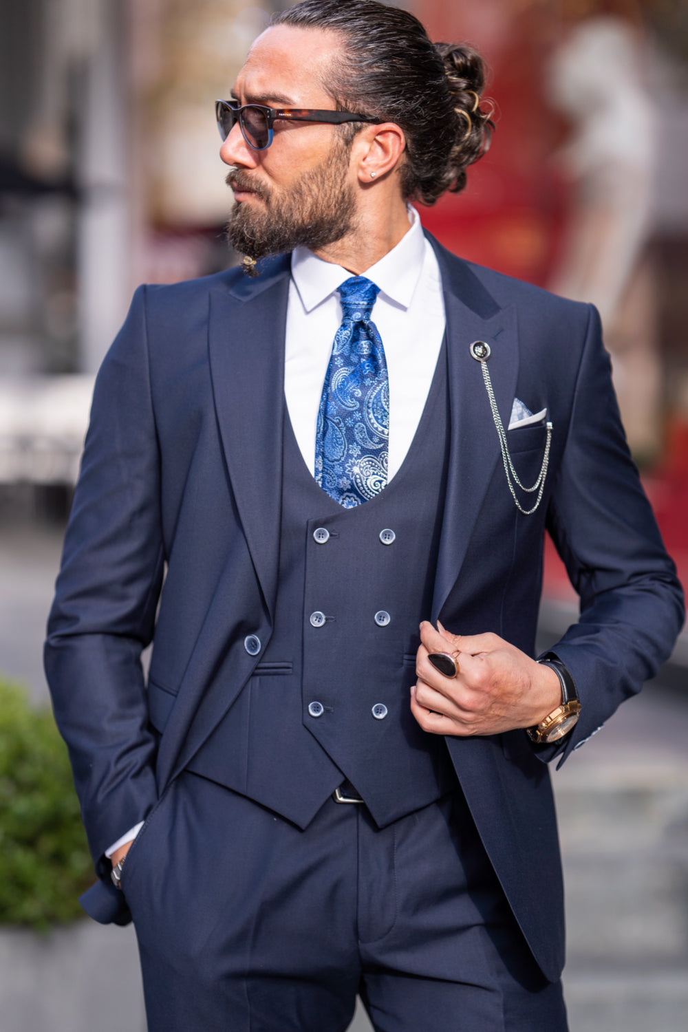 Classic navy tailored suit with vest by Mazonni, accessorized for stylish office or occasion wear
