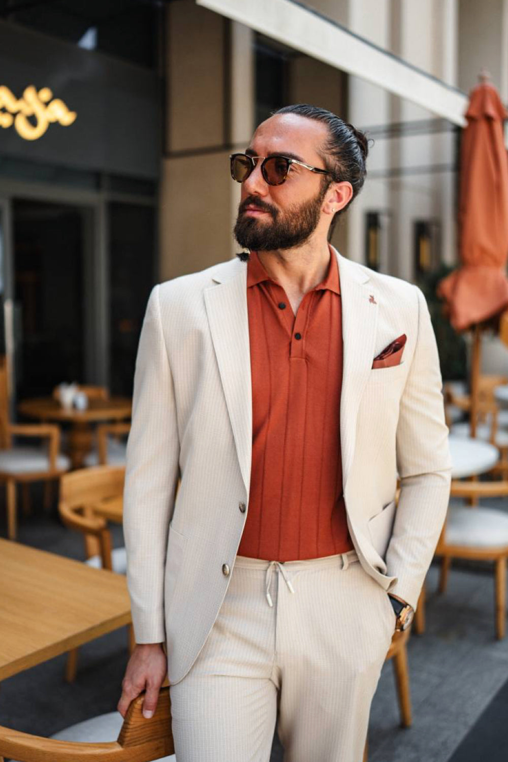 Sophisticated cream-colored men's suit by Mazonni paired with orange accents, great for stylish brunch or resort wear