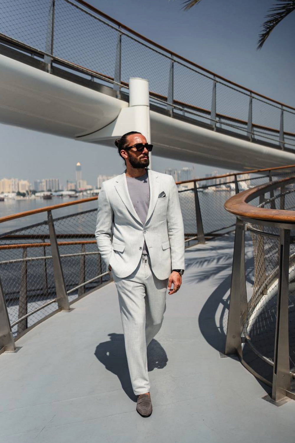 Soft grey Mazonni suit for men showcased with laid-back styling, great for smart casual or travel-ready fashion