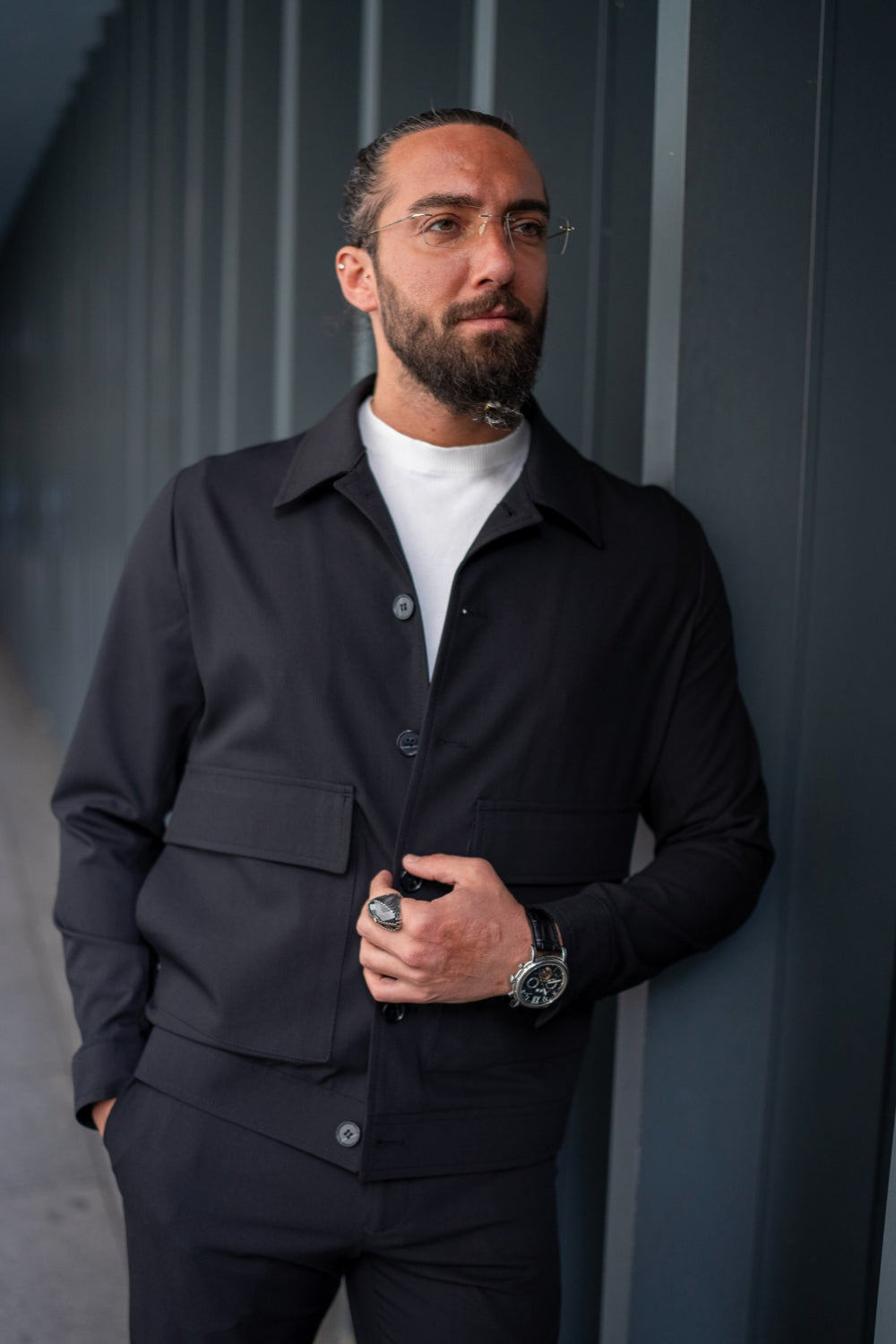 Slim fit dark grey suit by Mazonni for men, styled with casual footwear and accessories for a sleek urban outfit