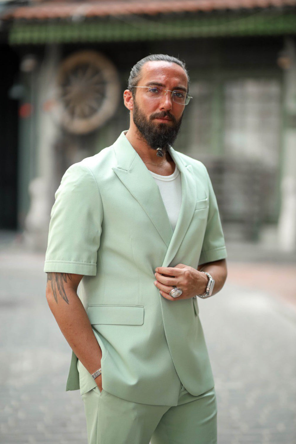 Modern men's summer suit in pastel mint green with casual streetwear vibe