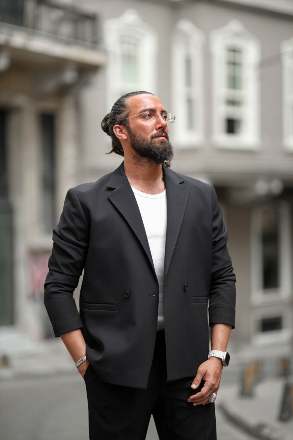 Stylish urban men's outfit featuring tailored black blazer and trousers
