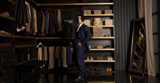 Man wearing a pinstripe Mazonni suit standing in a modern wardrobe — showcasing versatile suit options for everyday wear
