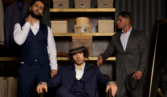 Three men in tailored Mazonni blazers posing in a dressing room — exploring proper blazer length and fit for modern menswear