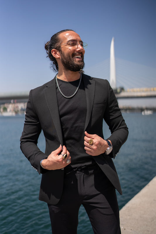 men's black blazer by Mazonni styled with black t-shirt and pants, minimalist smart casual outfit
