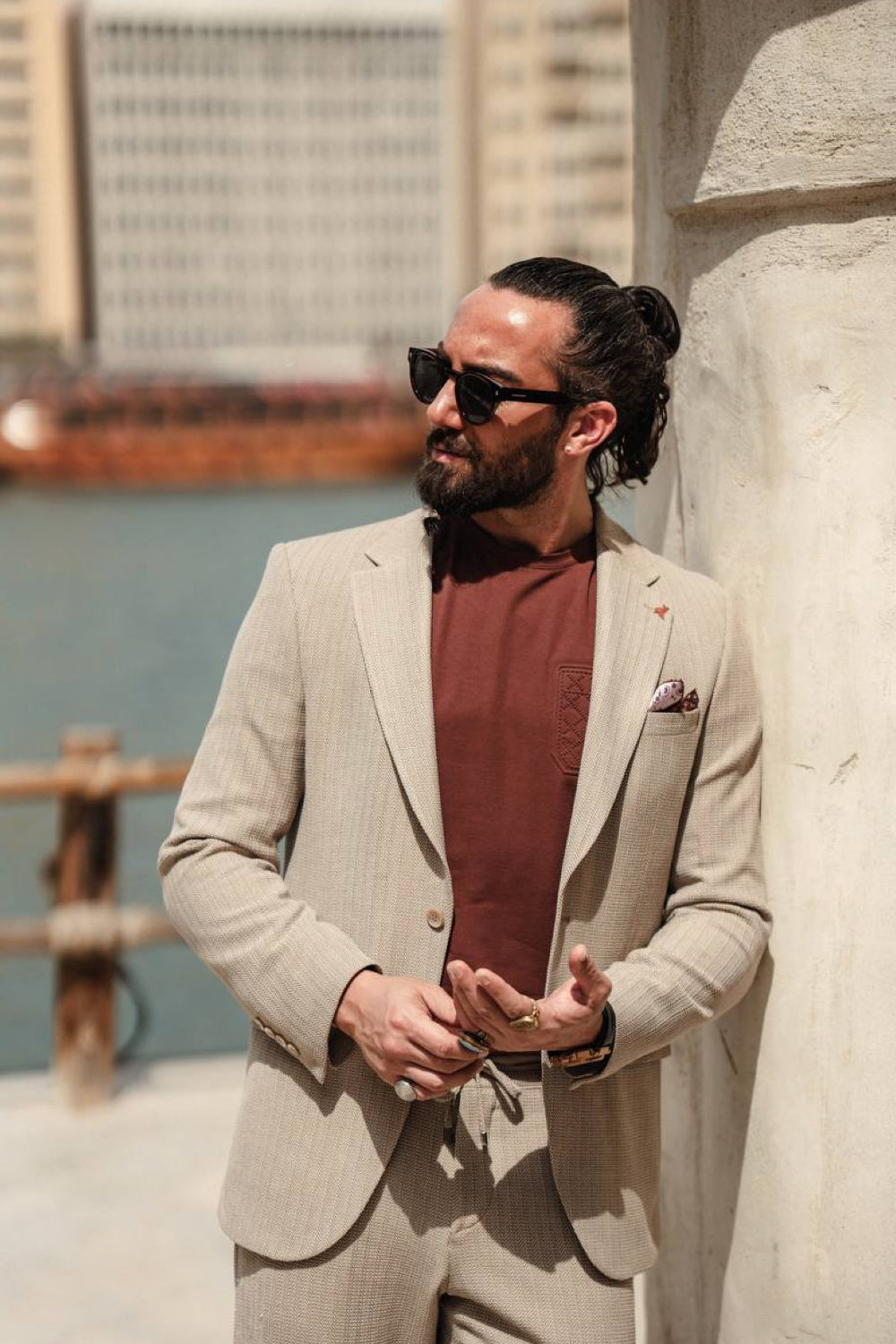 Light beige men’s suit from Mazonni styled with a terracotta t-shirt and pocket square, perfect for summer city fashion and smart casual events