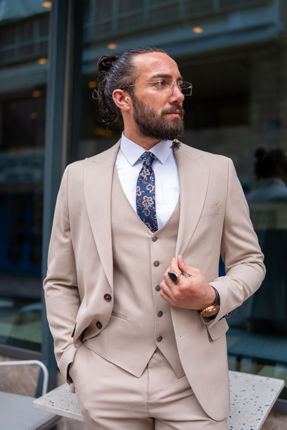 Elegant beige men’s suit by Mazonni styled with patterned tie, tailored for modern formal occasions