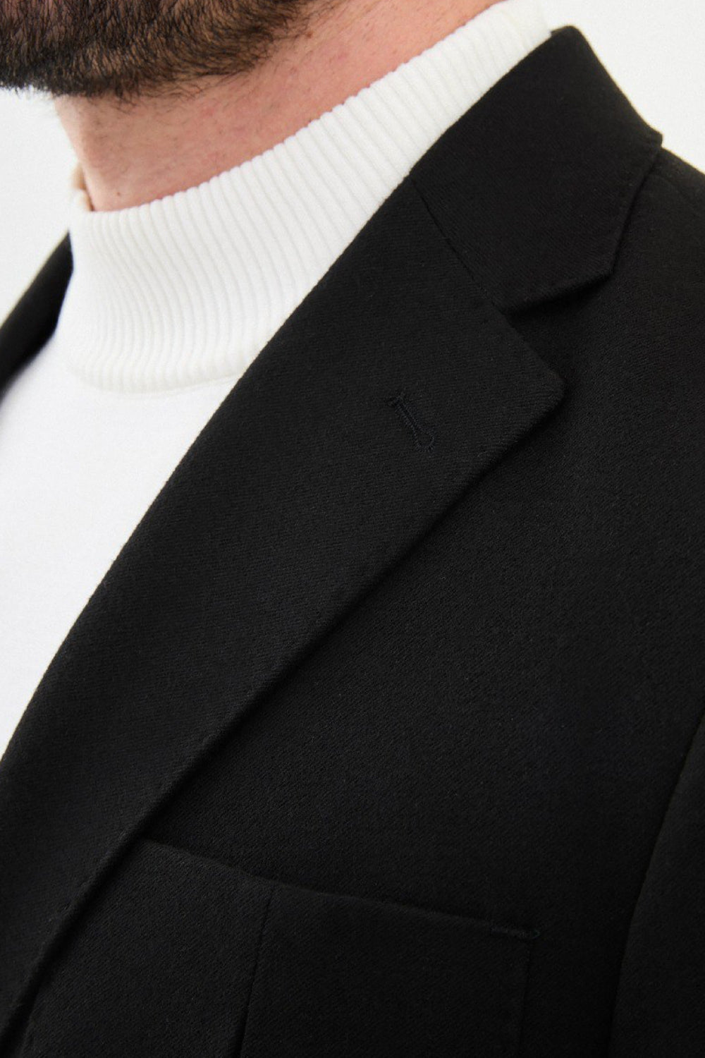 Detailed view of the black Mazonni men’s blazer showing lapel and pocket – essential piece for smart wardrobe