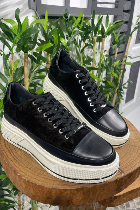 Black platform sneakers by Mazonni with contrasting white chunky sole and lace-up front