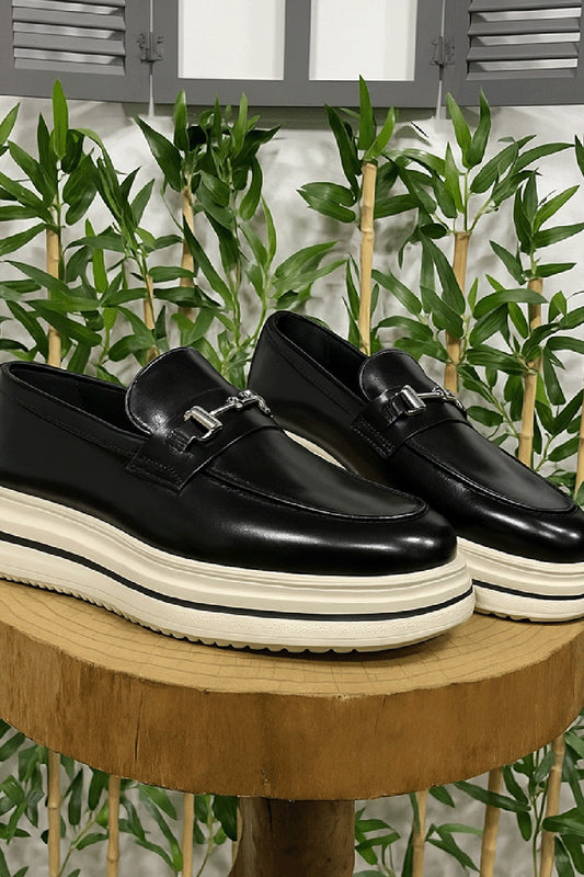 Black leather loafers for men by Mazonni with metal buckle and chunky white sole