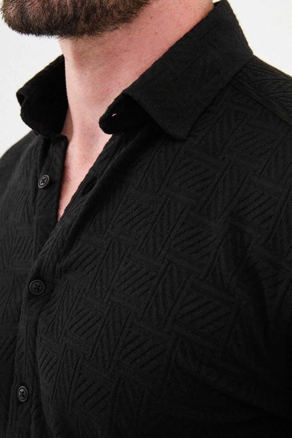 Elegant black shirt from Mazonni featuring subtle geometric patterns and slim cut