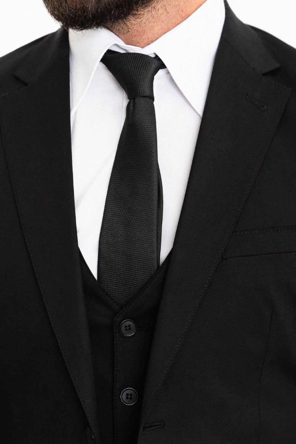 Formal black suit set for men by Mazonni, styled with a notch lapel blazer and fitted vest for timeless style
