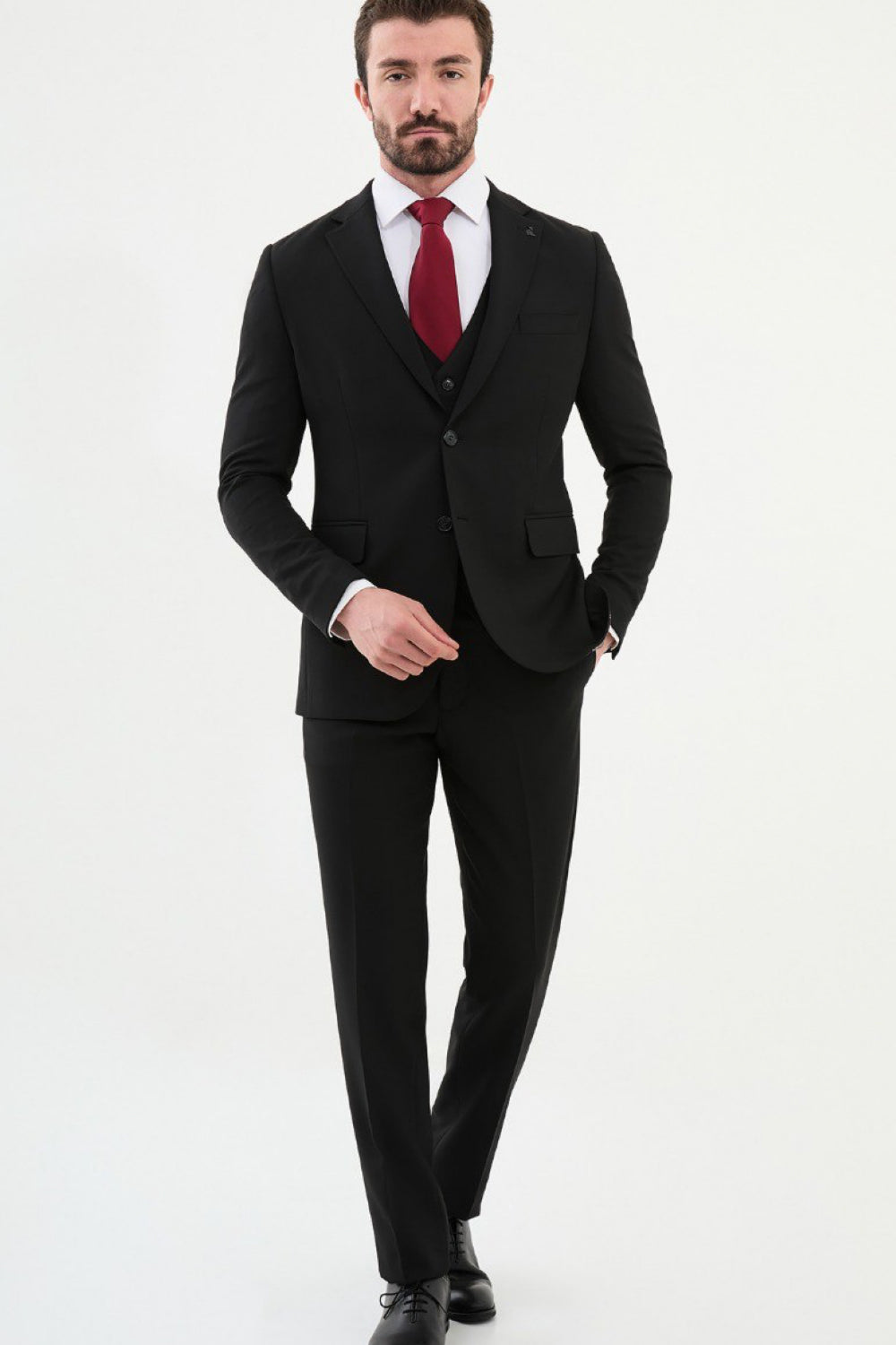 Side angle of Mazonni black suit with sharp cut and bold red tie, modern and elegant look for men