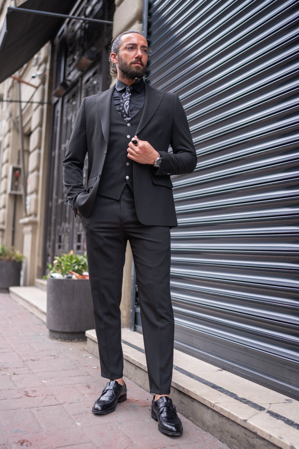 Black slim fit three-piece suit for men by Mazonni with patterned shirt, perfect for formal or evening wear