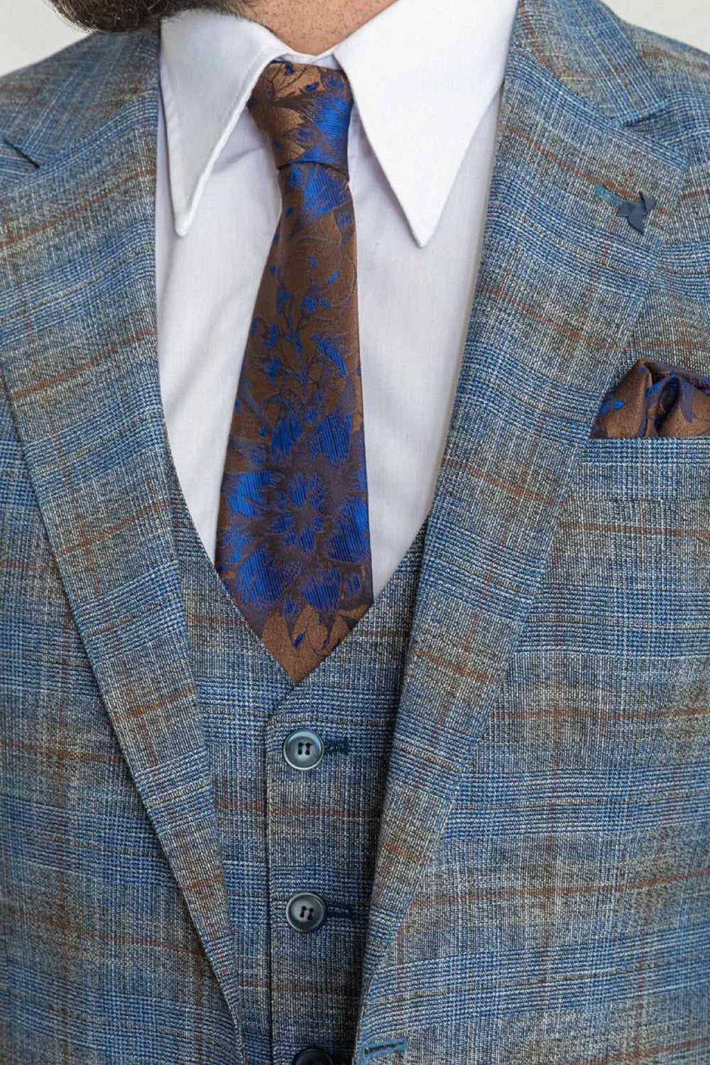 Close-up of Mazonni blue plaid suit with brown accents and elegant tie, classy men's fashion