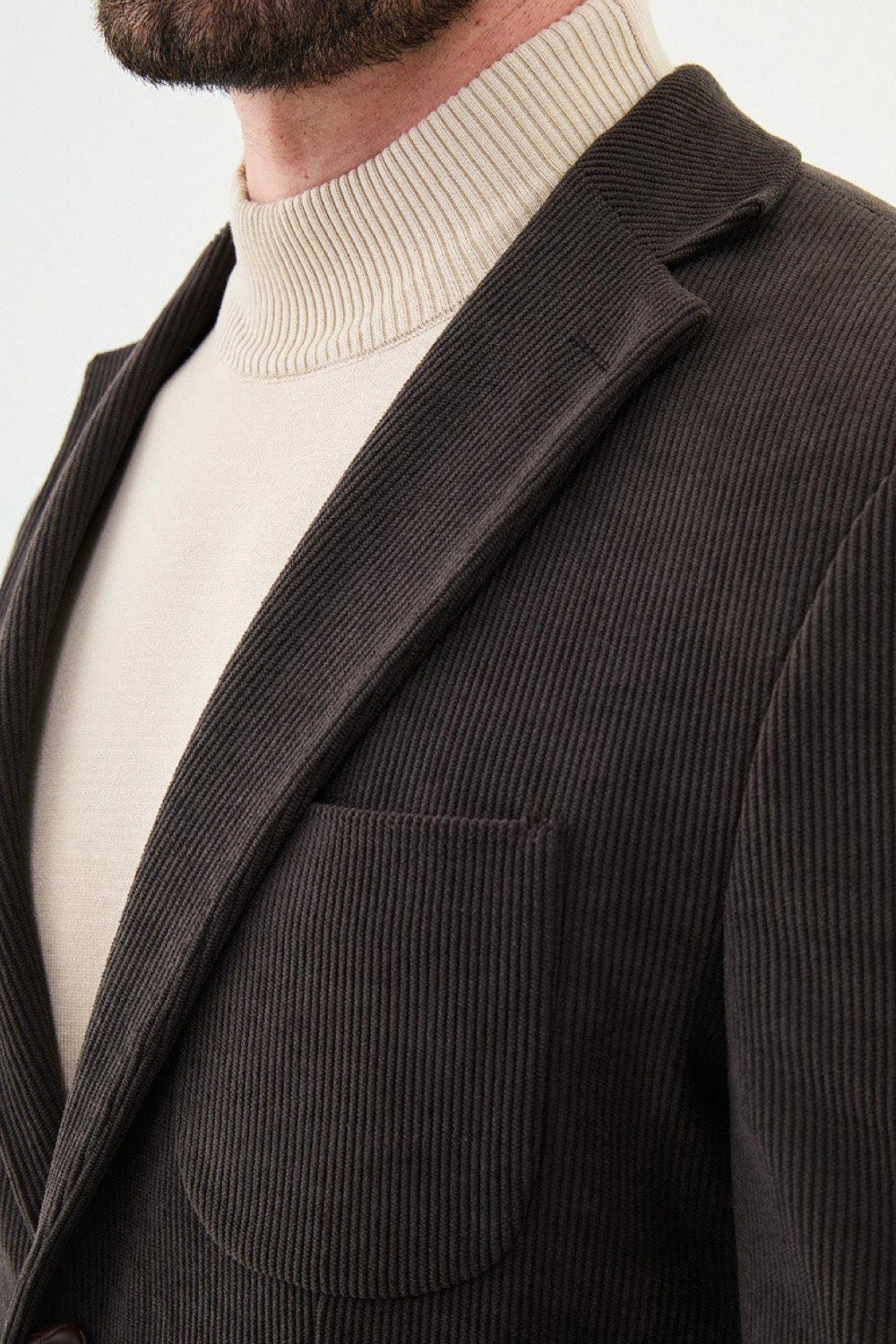 Close-up of dark brown Mazonni blazer showing ribbed texture and classic lapel – refined formal jacket for office or events