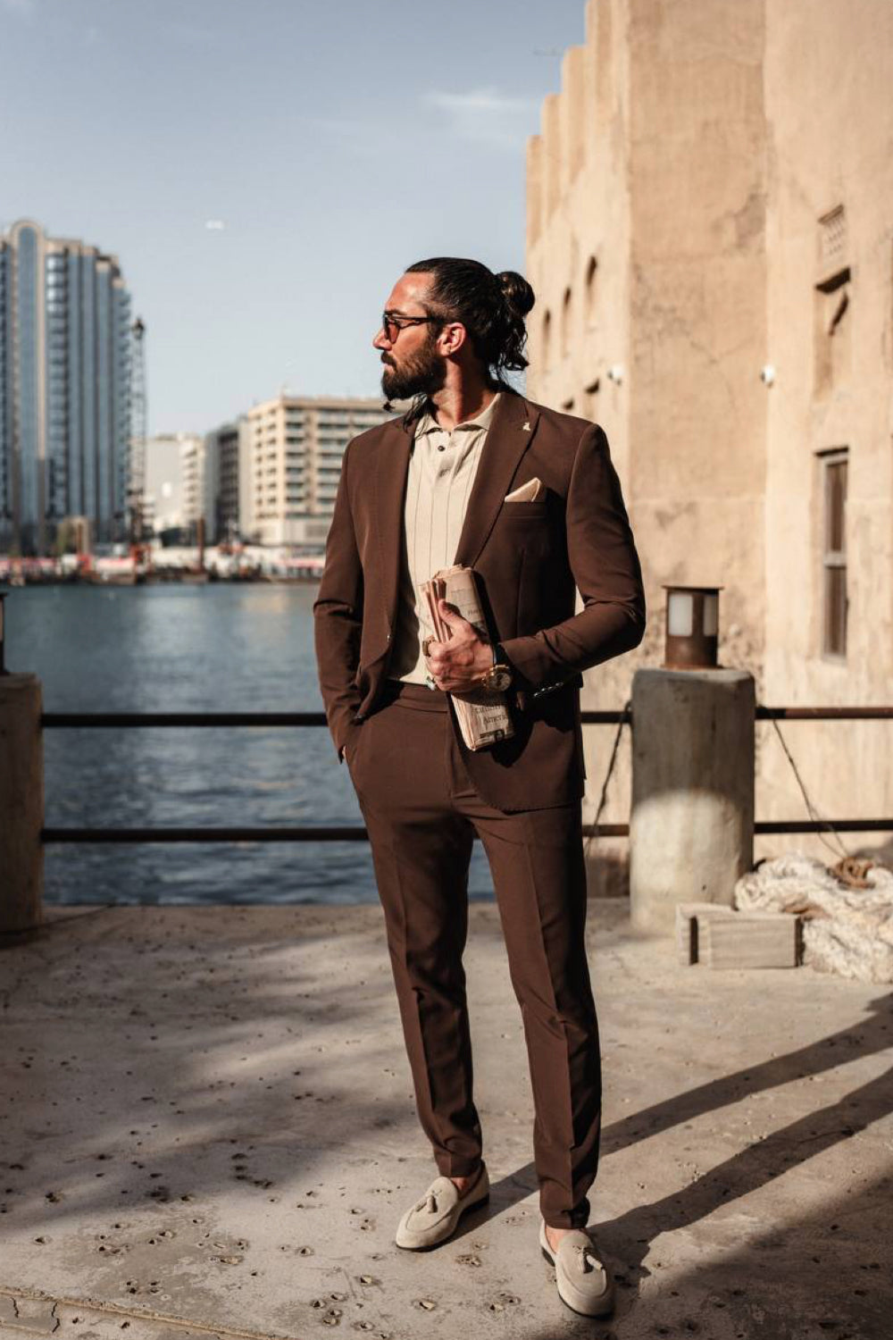 Dark brown Mazonni men's suit paired with a beige shirt and loafers, perfect for smart casual or business outings near the marina