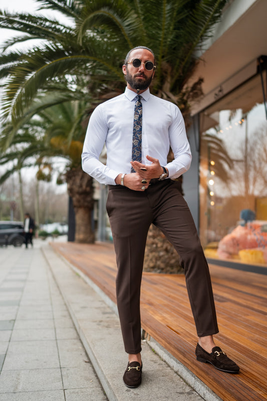 Brown slim-fit trousers for men by Mazonni paired with white shirt and loafers