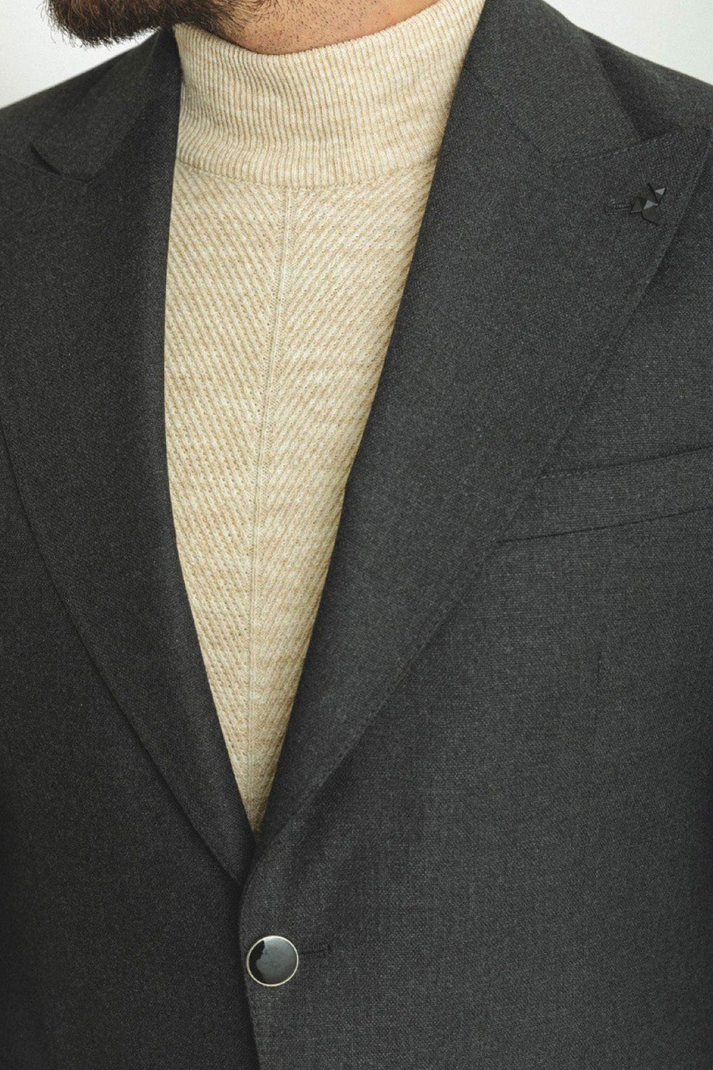 Slim fit dark gray suit by Mazonni, versatile outfit styled with a cream sweater for business casual occasions