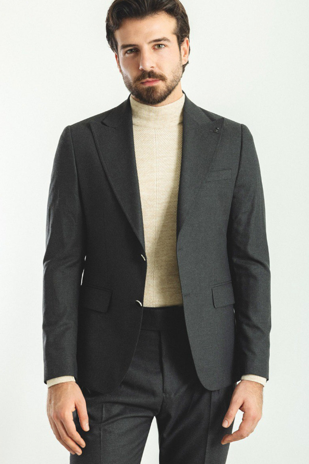Dark grey casual suit for men by Mazonni, paired with beige turtleneck for a smart modern look