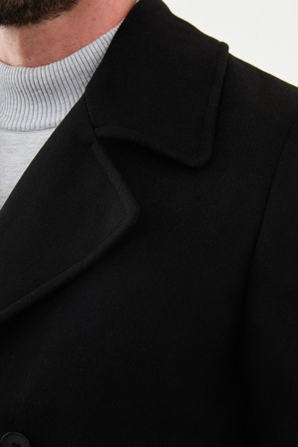Men’s black wool peacoat by Mazonni featuring wide lapels and tailored fit