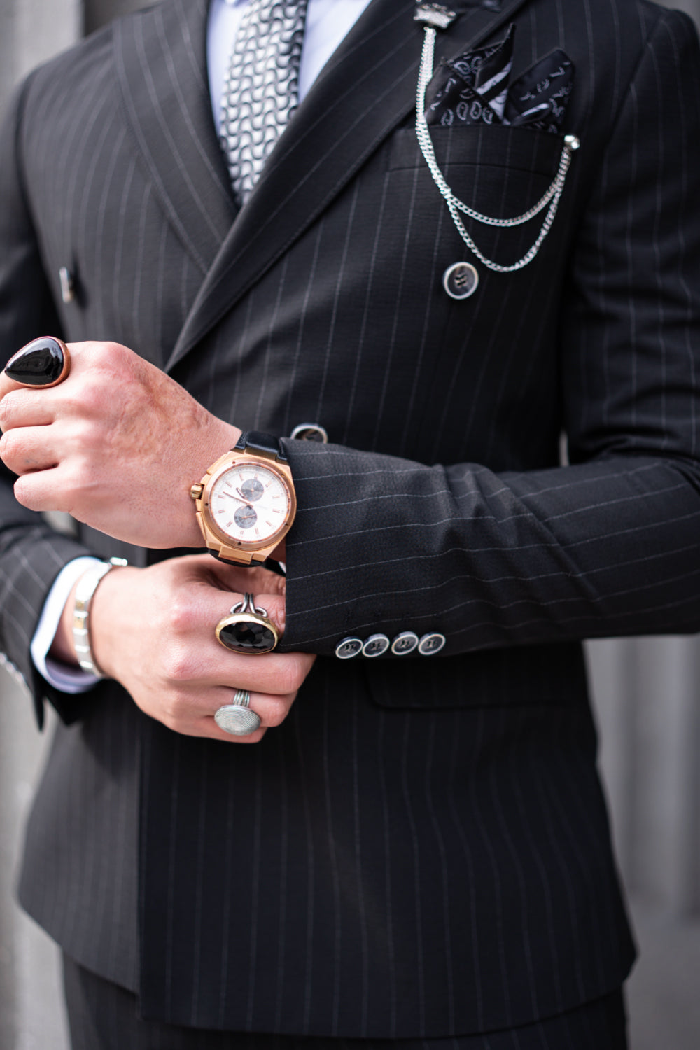 Men’s black striped Mazonni suit, professional style with luxury watch and sunglasses