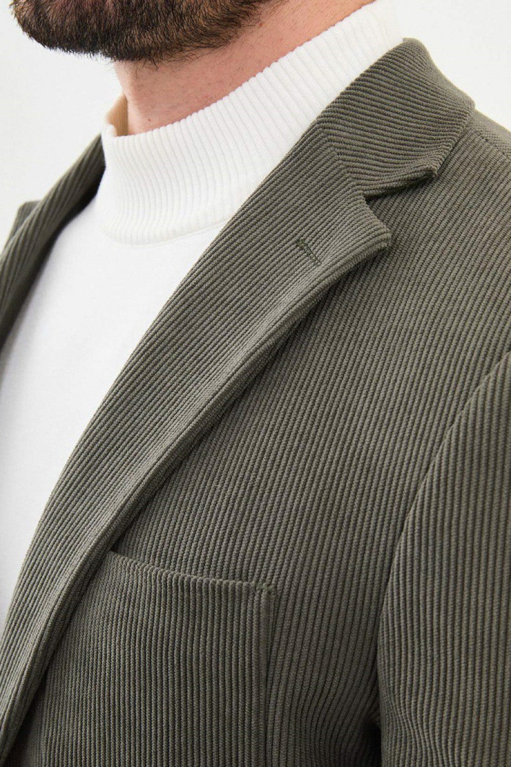 Close-up of sage green Mazonni blazer with wide wale corduroy texture and notched lapel – modern textured formal jacket