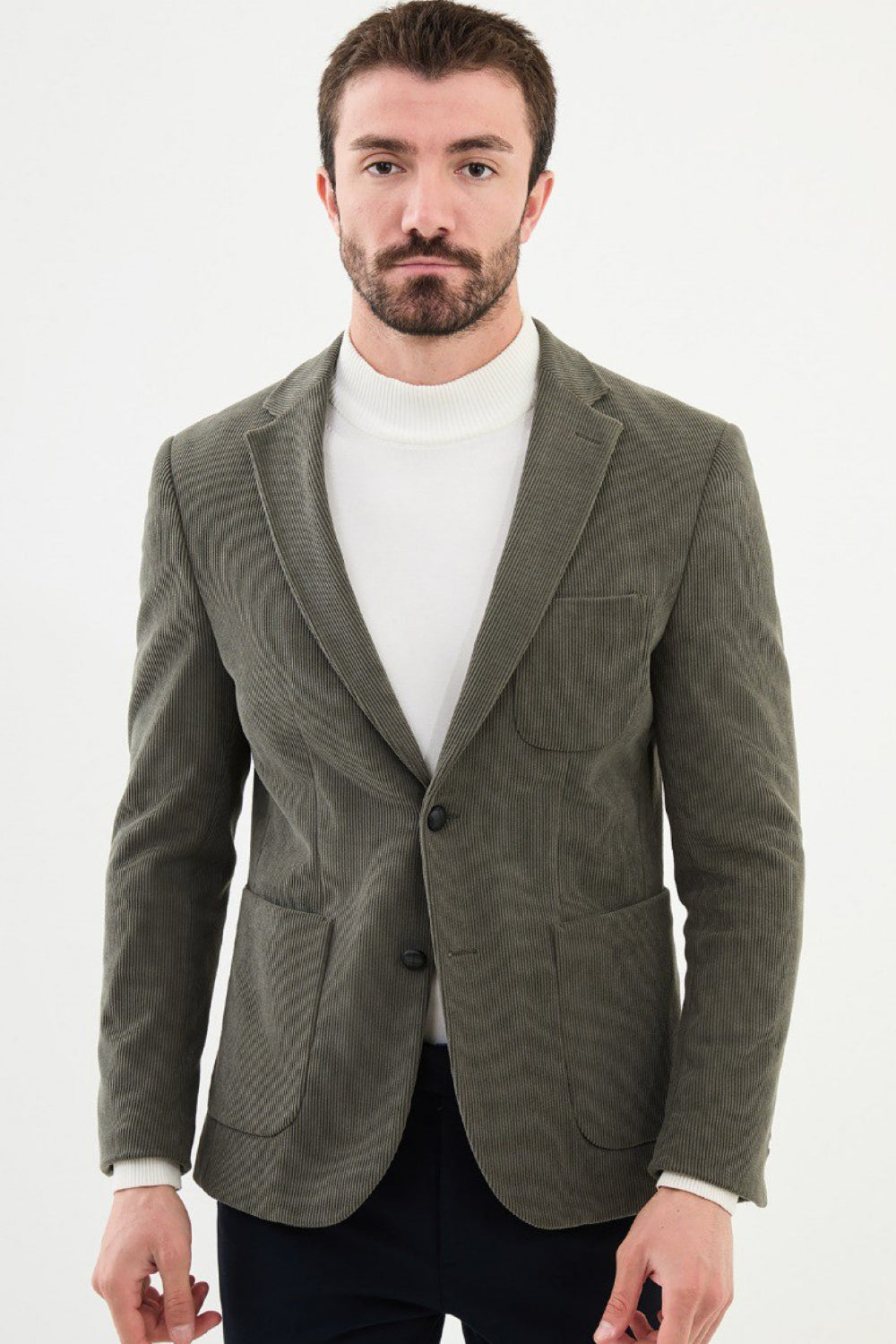 Sage green corduroy men’s blazer by Mazonni styled with white turtleneck – relaxed smart casual blazer for men