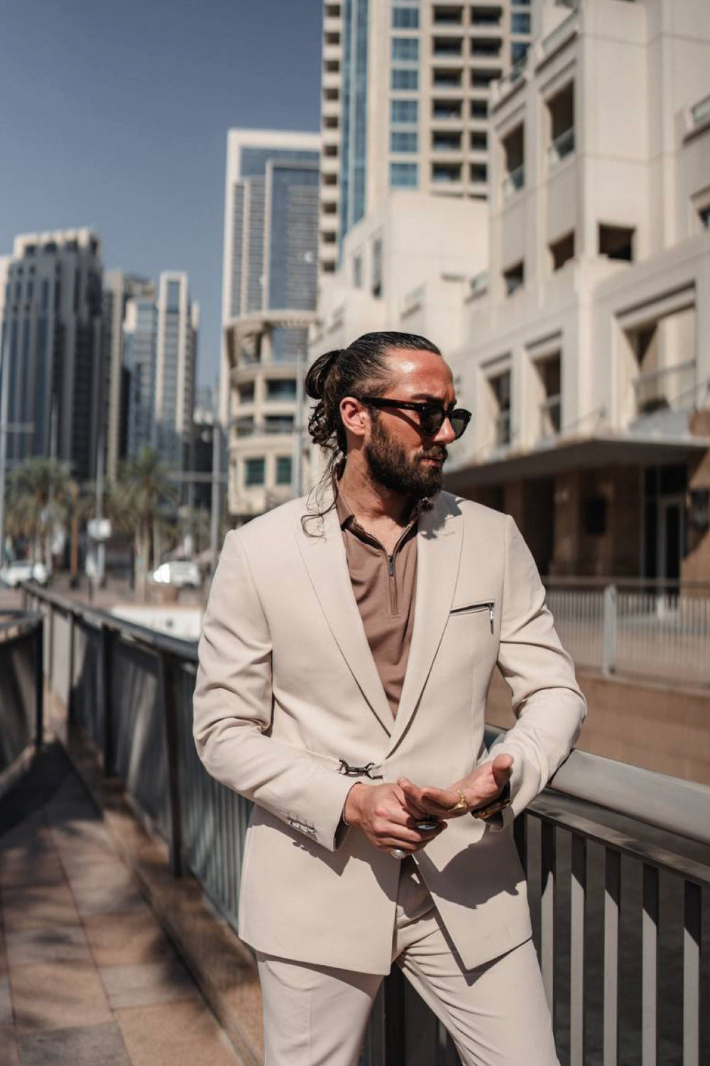 Light beige Mazonni men's suit styled with a brown shirt and sunglasses, perfect for smart summer city fashion