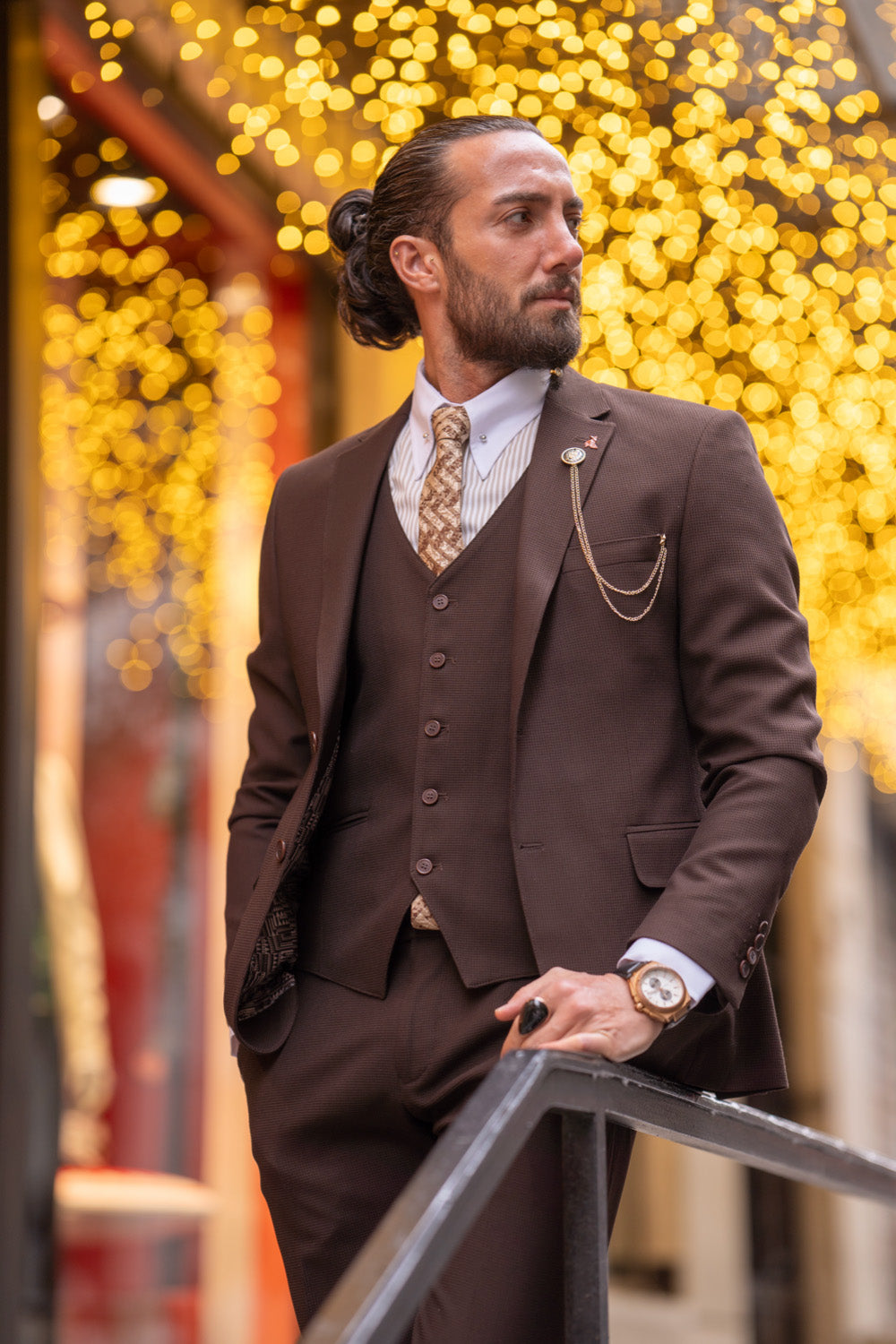 Stylish dark brown suit by Mazonni featuring classic tailoring and a subtle checkered tie, ideal for business or events