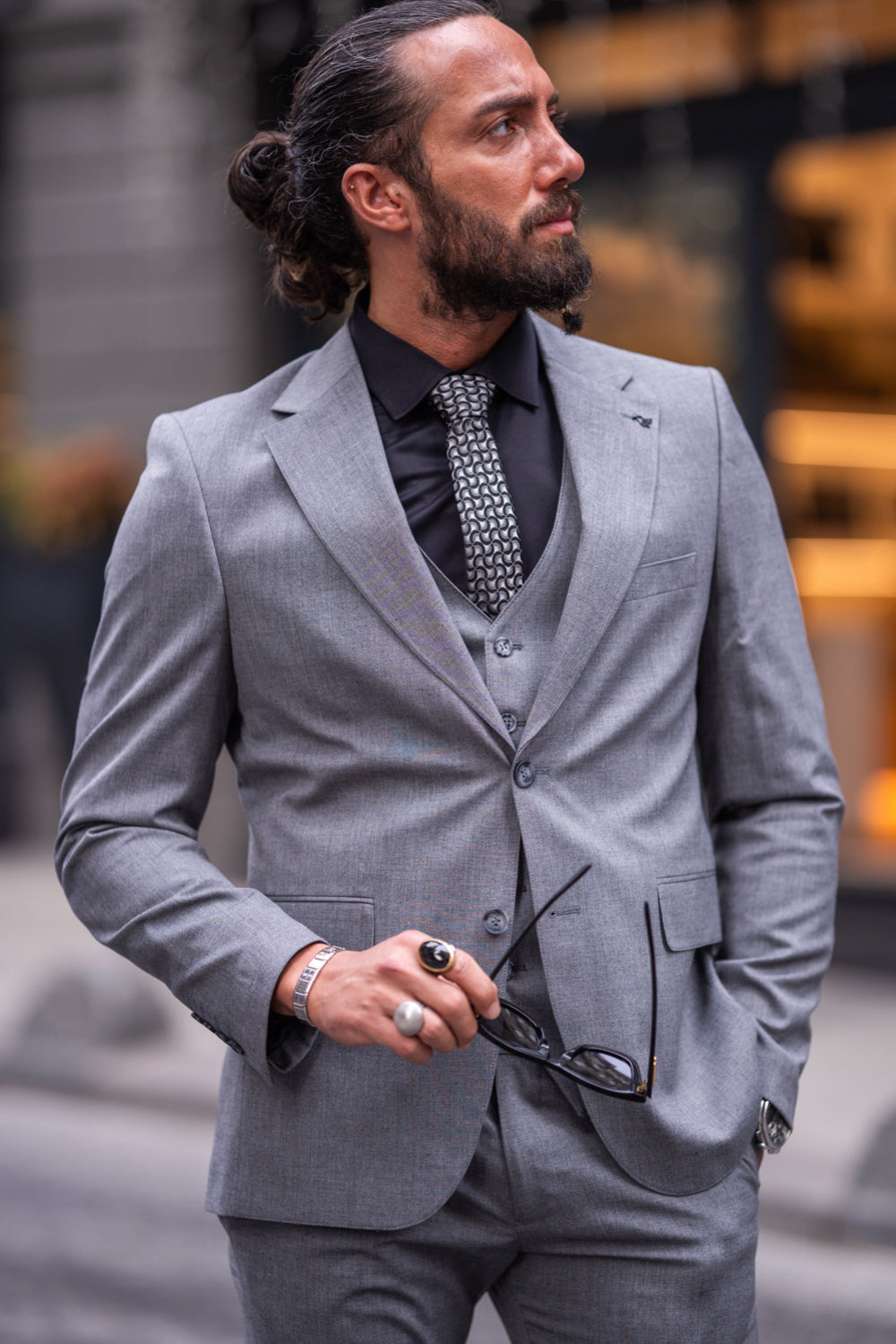 Mazonni light grey formal suit with black dress shirt and loafers, styled for contemporary urban fashion