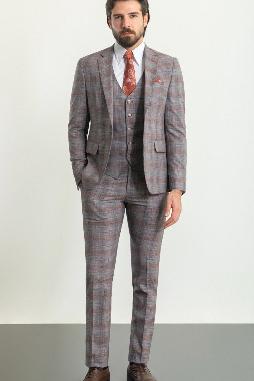Mazonni men's three-piece suit in gray and brown check pattern with orange tie, sophisticated formalwear