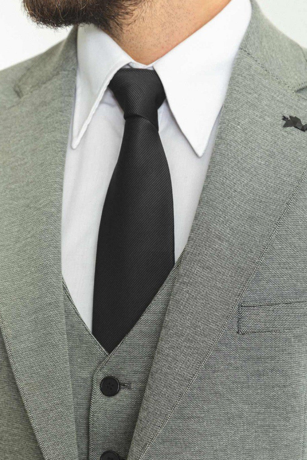 Close-up of Mazonni light gray suit with black tie and waistcoat, classic men's formalwear