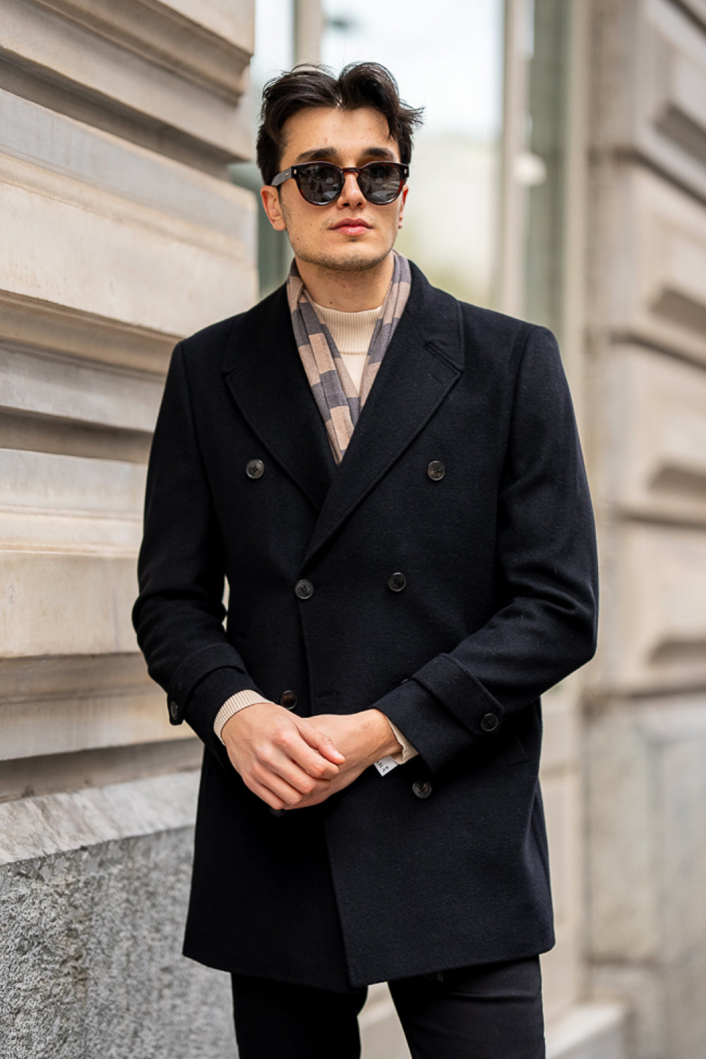 Stylish men's Mazonni coat paired with slim trousers, ideal for a polished streetwear ensemble