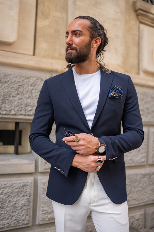 navy blue blazer for men by Mazonni paired with white pants and t-shirt, perfect smart casual summer look
