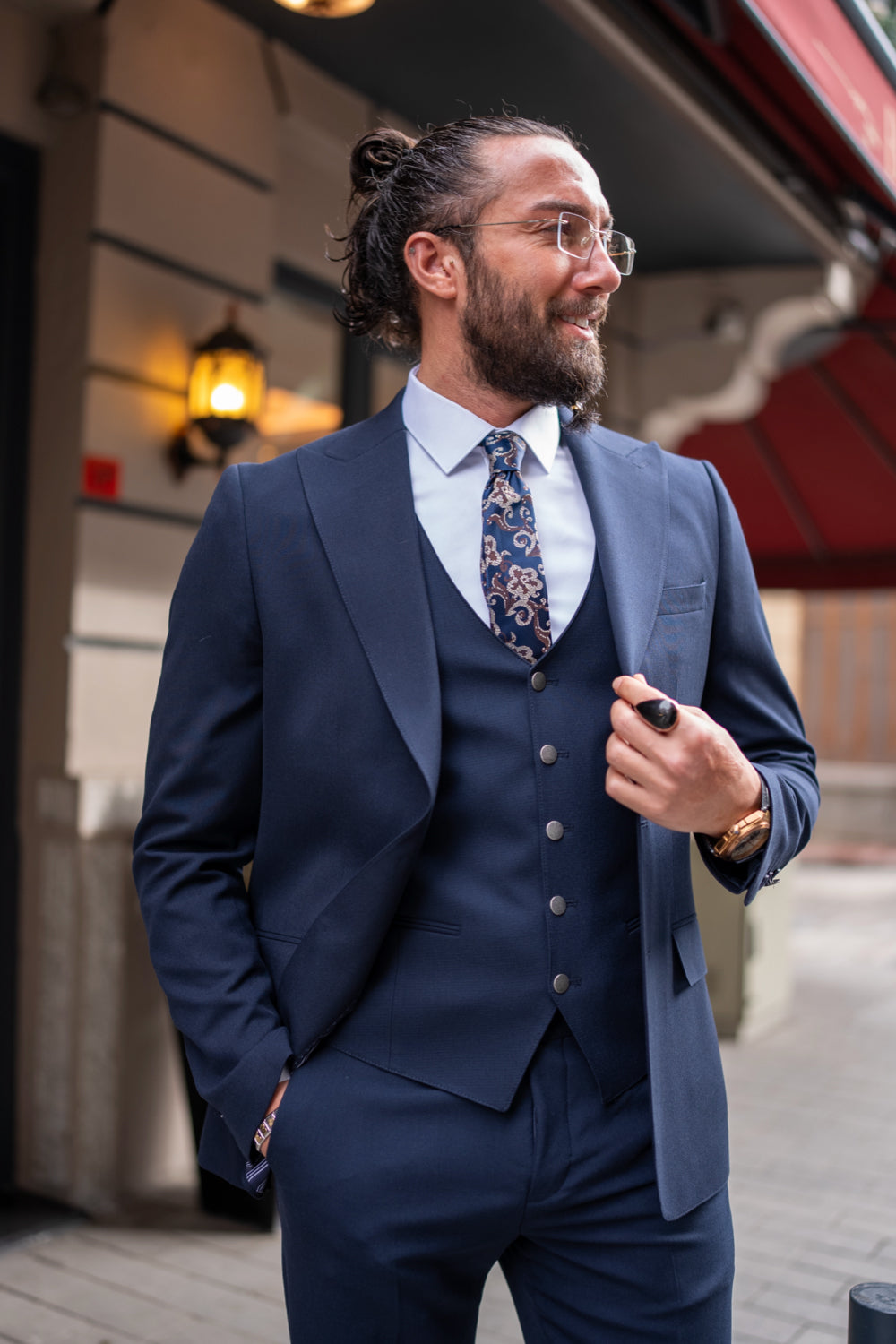 Three-piece dark blue suit by Mazonni styled with a patterned tie, perfect for elegant evening wear