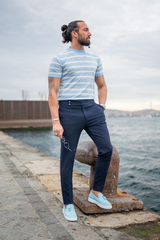 Navy blue tailored trousers for men by Mazonni styled with striped tee and loafers