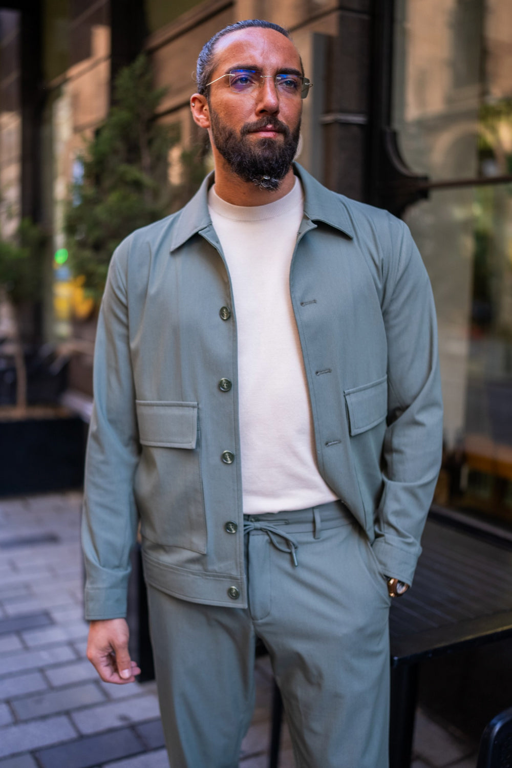Light sage green Mazonni men's suit with patch pockets and cream knit shirt for a fresh smart casual look