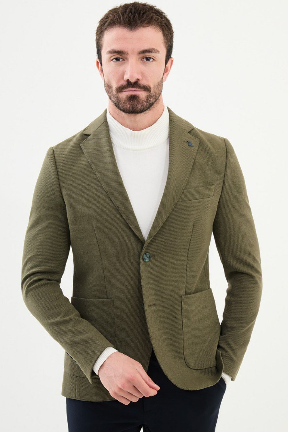 Olive green blazer by Mazonni styled with white turtleneck and navy trousers – smart casual men’s blazer perfect for both work and leisure