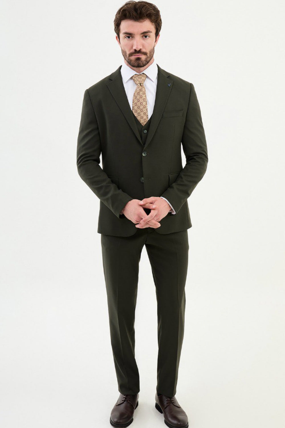 Front view of dark green Mazonni suit with white shirt and vest, refined menswear look for modern professionals