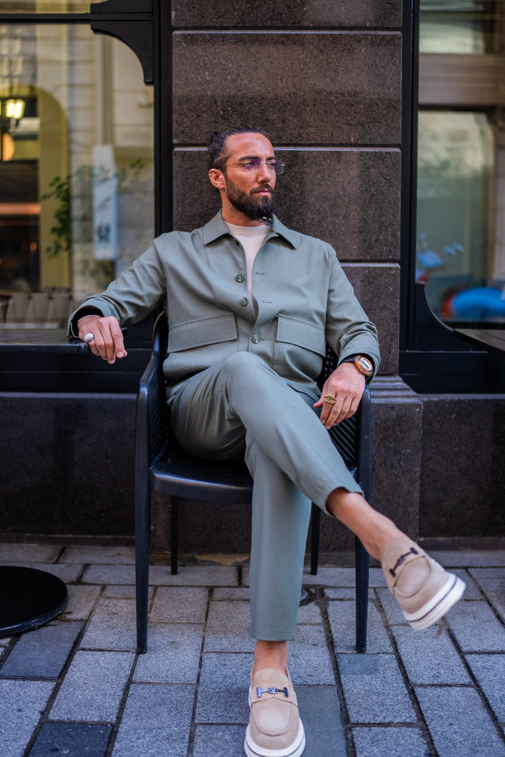 Men's sage green fashion suit by Mazonni, paired with sneakers for a modern and comfortable city style