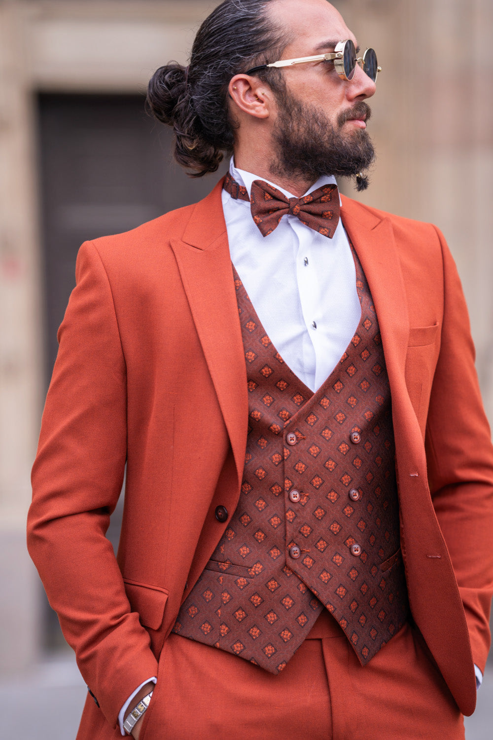 Elegant men’s terracotta suit by Mazonni with contrast buttons and tuxedo styling, ideal for special events