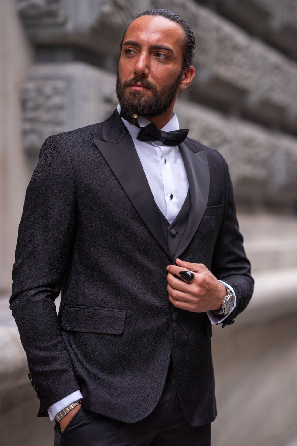 Formal black dinner suit with vest and tailored fit by Mazonni, styled with loafers for modern elegance