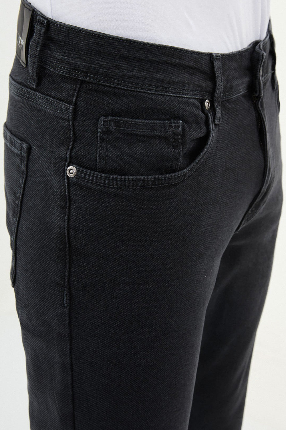 Men’s dark black denim pants by Mazonni with narrow leg and zip fly